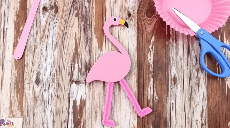 A pink cupcake liner made in the design of a flamingo.