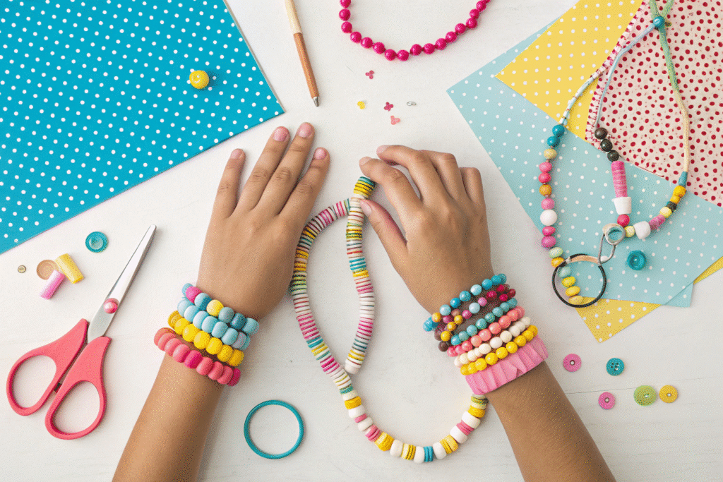 Hands adorned with colorful paper bead necklaces and paper rings are displayed against a backdrop of various craft supplies, showcasing a fun and creative paper craft project. Scissors, glue, and patterned paper can be seen, highlighting the joy of crafting with paper.