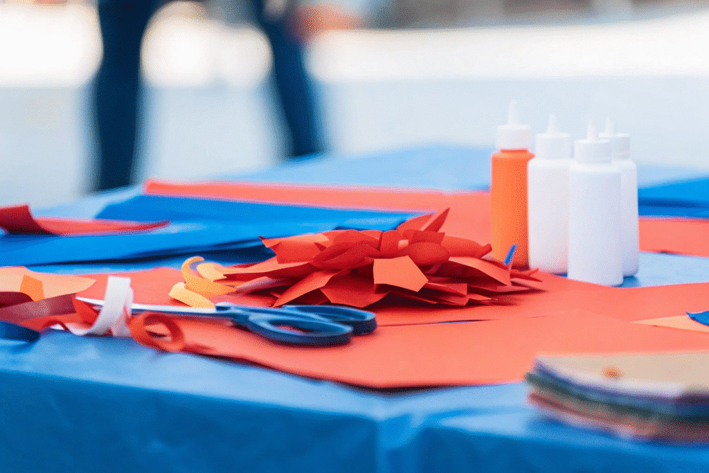The image showcases a crafting table filled with a variety of colorful paper craft supplies, including scissors, glue, and construction paper, alongside finished projects like paper flowers and paper chains. This vibrant scene highlights the joy of paper crafting and the creativity involved in fun paper craft ideas.