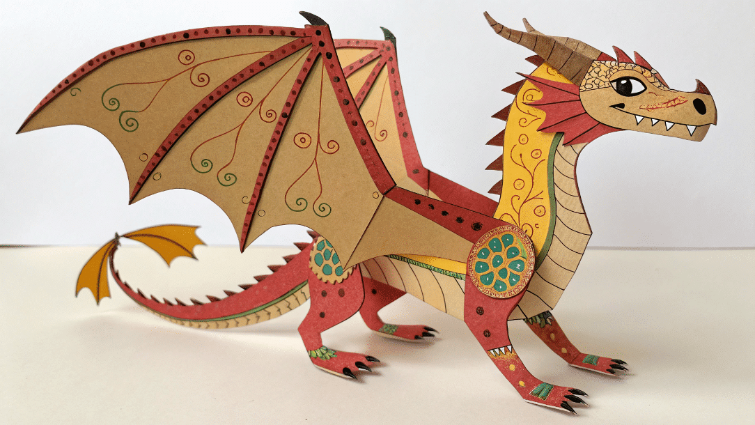 5d575b89e0fd4912b52639a6d1b65ca7 simply paper crafts Jointed dragon puppet on a table