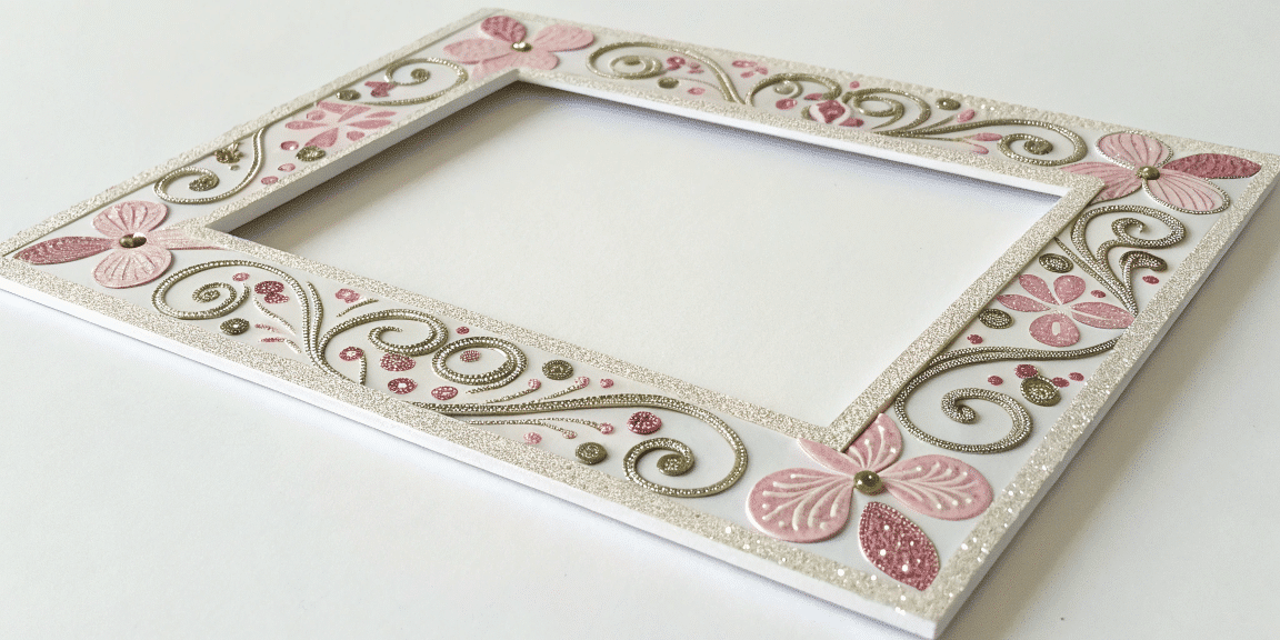 8f826e8e2177459c838dd6e07e66e1c0 simply paper crafts A close up photo of a decorative framed artwork with a border featuring intricate designs in shades of pink and gold