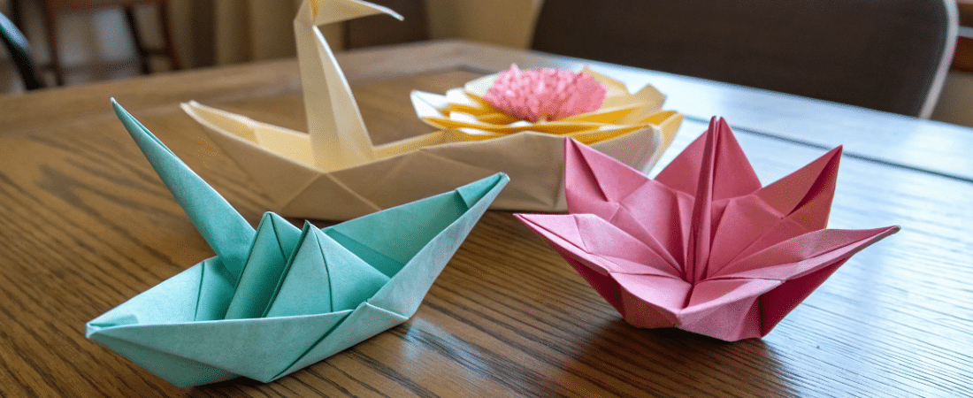 A photo of a wooden table showcasing various origa simply paper crafts A photo of a wooden table showcasing various origami creations