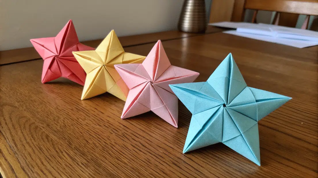 Folding Origami Paper Stars on a wooden table