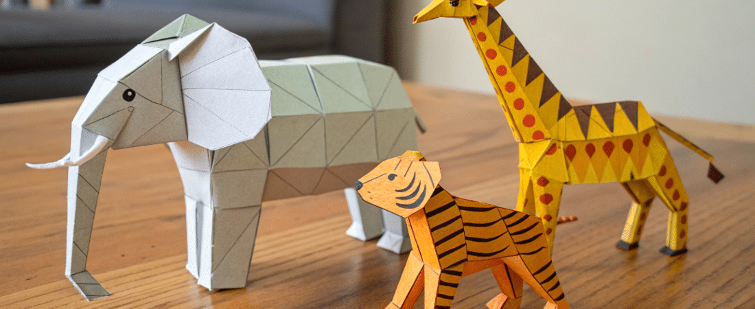 Animals paper crafts simply paper crafts A photo featuring a variety of origami animal models including a large elephant a smaller tiger like creature and a giraffe
