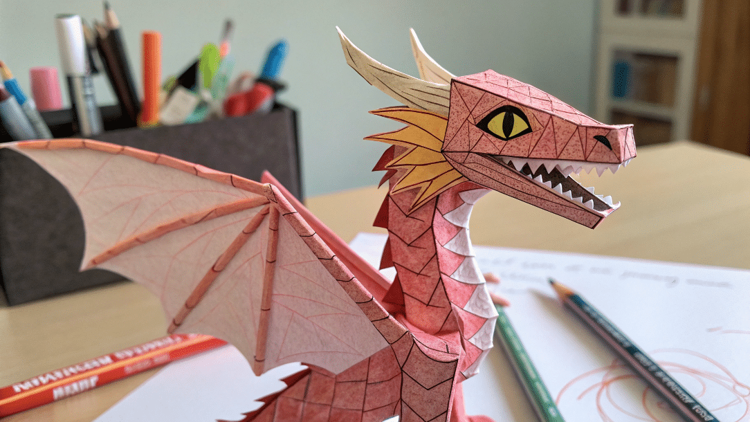 B45bfeb4dd4147588d7ce6748404f6b1 simply paper crafts Mini origami dragon puppet next to pens in a pot