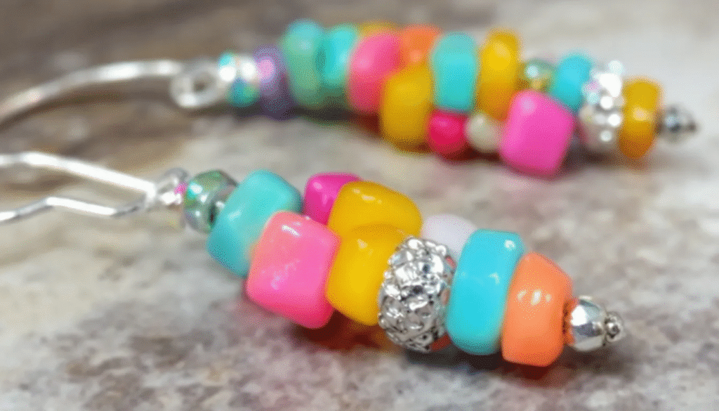 Image simply paper crafts The image features a pair of colorful earrings made from tiny round paper beads in various shapes and hues strung on delicate earring hooks These playful accessories showcase the creativity of paper bead jewelry perfect for adding a vibrant touch to any outfit