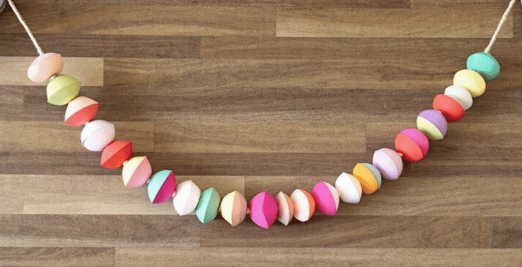 Image simply paper crafts Different colored paper bead garlands on a wooden background