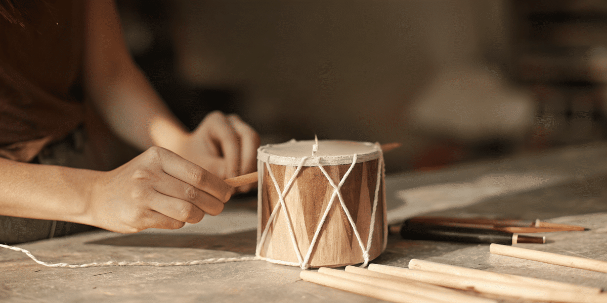 12d65d3a5d70445682367359eb113e0c simply paper crafts Apaper cup resemblin a drum with a person holding a pencil