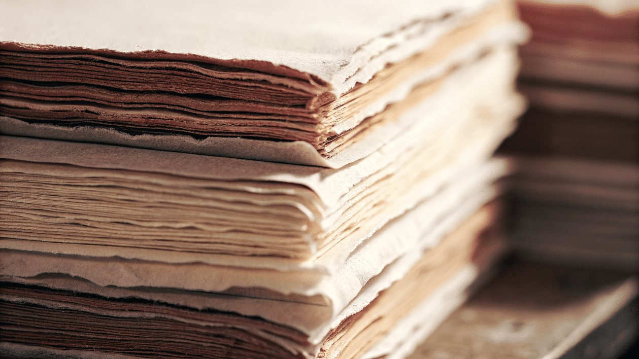 7366568d19ea489ba1acb0f2974b32ea simply paper crafts A pile of deckled edged papers stacked up
