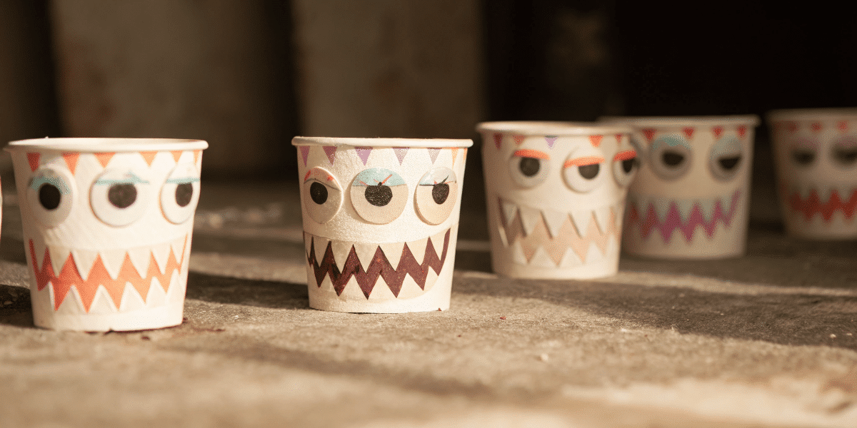 Ef83277297ff4a1191334e1510cb8b50 simply paper crafts A photograph with a series of multiple paper cup shaped objects with various monster patterns including geometric and ornamental designs