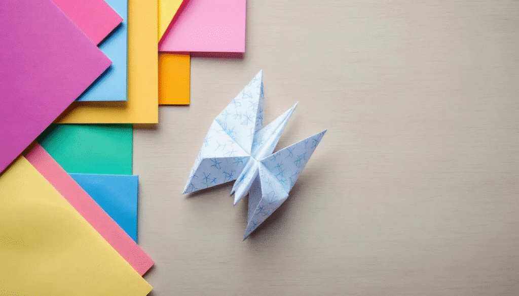 In the image, various types of paper are displayed side by side for comparison, including colorful construction paper, delicate origami paper, and sheets of printer paper. Each type of paper showcases its unique texture and thickness, illustrating the different materials suitable for crafts and origami projects.