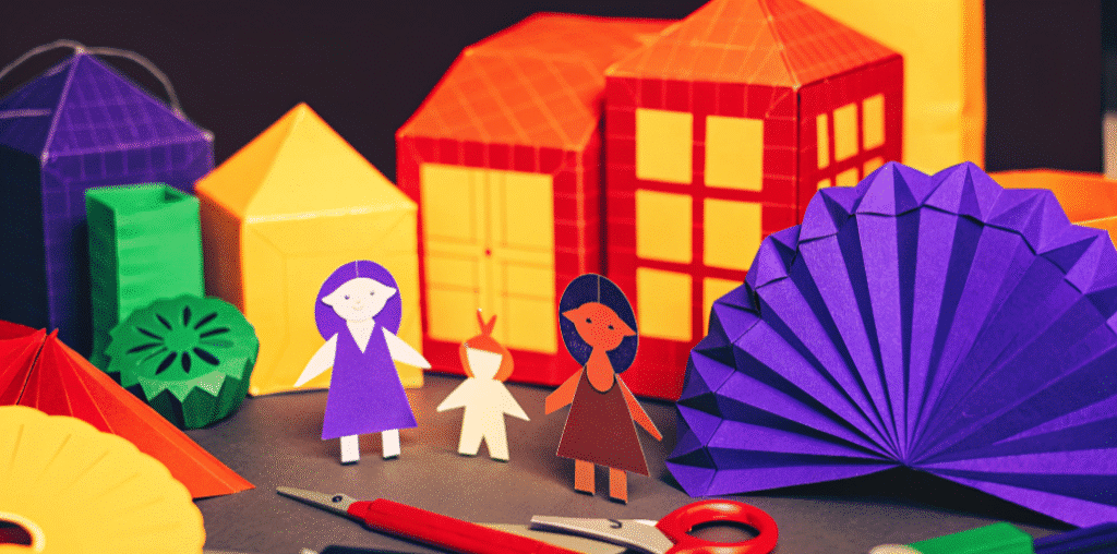 Colorful paper craft items simply paper crafts The image showcases a vibrant assortment of colorful paper crafts including origami shapes paper dolls and intricate paper models Scattered around are free templates and tools inviting both kids and adults to explore their creativity through fun activities like folding and cutting paper to create unique toys and decorations