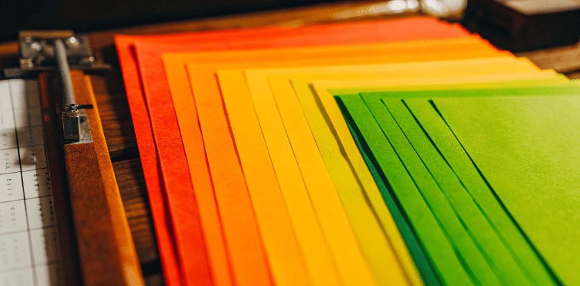 Crafting techniques simply paper crafts An image of a crafting workspace featuring colorful paper strips neatly arranged alongside a paper weaving tool often called a needle with a clip at the end for easy handling The scene captures the essence of creativity and simplicity in paper weaving projects inviting artists to explore their imagination