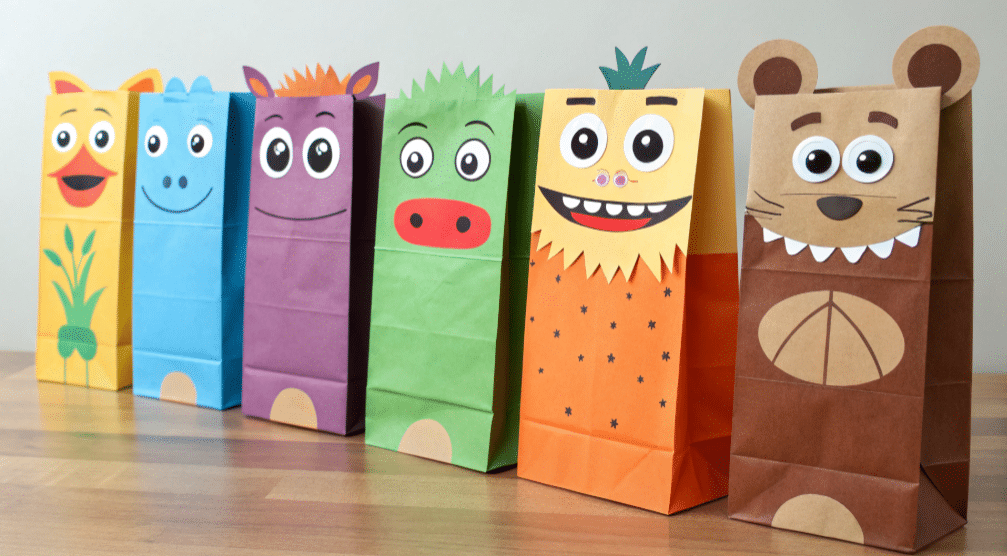 Different paper bag puppet faces simply paper crafts The image showcases a collection of colorful paper bag puppets featuring various characters such as animals monsters and people each with unique eyes noses mouths and ears that give them distinct personalities This fun project encourages creativity in children inspiring them to explore their imagination while using simple materials like colored paper and glue