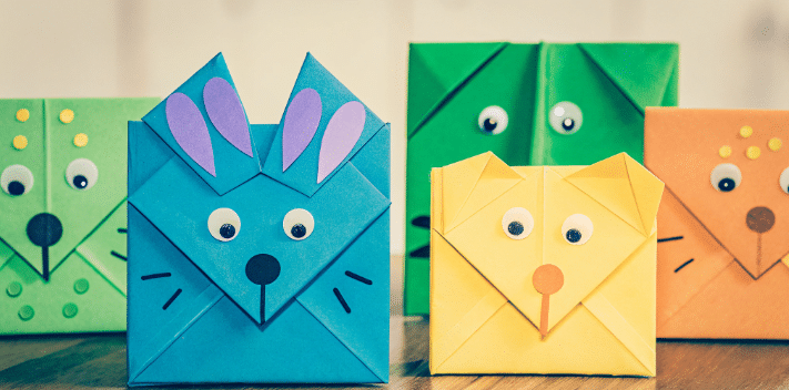 Different puppets simply paper crafts The image showcases a variety of colorful origami finger puppets each featuring different ear shapes and decorations transforming them into unique characters like a cat dog bear and rabbit The puppets are made from a square piece of printable origami paper demonstrating the fun and creativity involved in folding and decorating these playful figures for kids