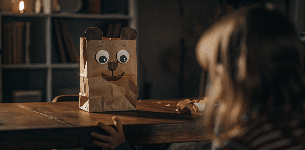 Home paper bear puppet simply paper crafts The image depicts a cheerful bear paper bag puppet crafted from a brown paper bag featuring googly eyes and a cute nose This fun project showcases the bear's ears and paws, making it an engaging craft for kids to enhance their creativity and fine motor skills.