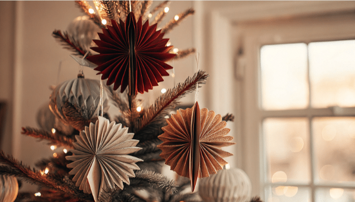 Homemade paper ornament simply paper crafts The image features a beautifully decorated Christmas tree adorned with homemade paper ornaments in various shapes and colors showcasing unique designs made from nice quality paper and old book pages This festive display highlights the charm of DIY decorations perfect for creating a personalized holiday atmosphere