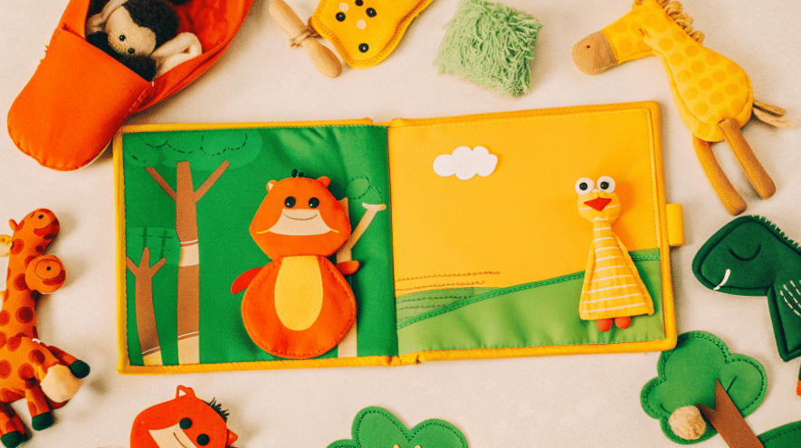 How to use puppet books simply paper crafts The image shows a colorful puppet book surrounded by various puppets toys and props inviting children to engage in storytelling The scene conveys the fun of using puppet books to enhance storytime with interactive elements making it enjoyable for toddlers and babies alike