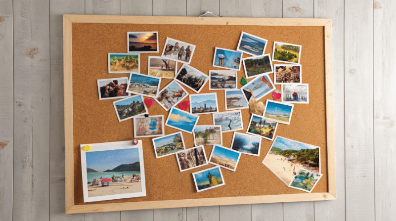 Photo collage simply paper crafts The image features a vibrant photo collage showcasing a mix of favorite photos arranged creatively on a cork board with some images forming a heart shape This DIY photo craft serves as a personalized home decor piece capturing cherished memories of family and friends in one colorful display