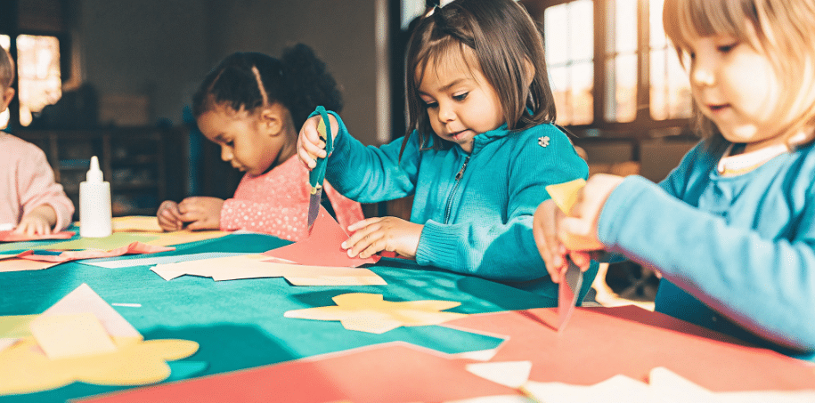 Preschool crafts classroom simply paper crafts The image depicts a group of preschoolers engaged in various craft activities using scissors glue and colorful materials to create art projects This fun and creative time helps develop their fine motor skills and encourages self expression showcasing the joy of crafting in a classroom setting