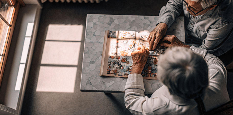 Two seniors crafting simply paper crafts An elderly person is engaged in a crafting activity focused on creating a colorful collage using various materials This scene highlights the joy and emotional benefits of crafts for seniors showcasing how such activities can enhance fine motor skills and provide a sense of connection and accomplishment