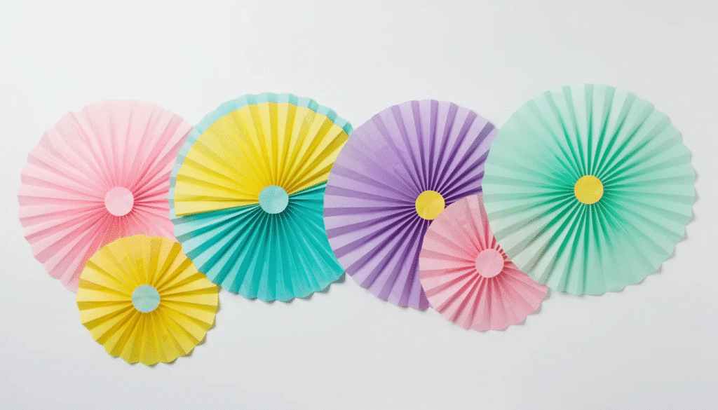 The image features a colorful array of DIY tissue paper fans perfect for decorating a birthday party or baby shower The fans made from folded tissue paper are displayed in various sizes and patterns showcasing their festive appeal as they hang elegantly against a wall backdrop