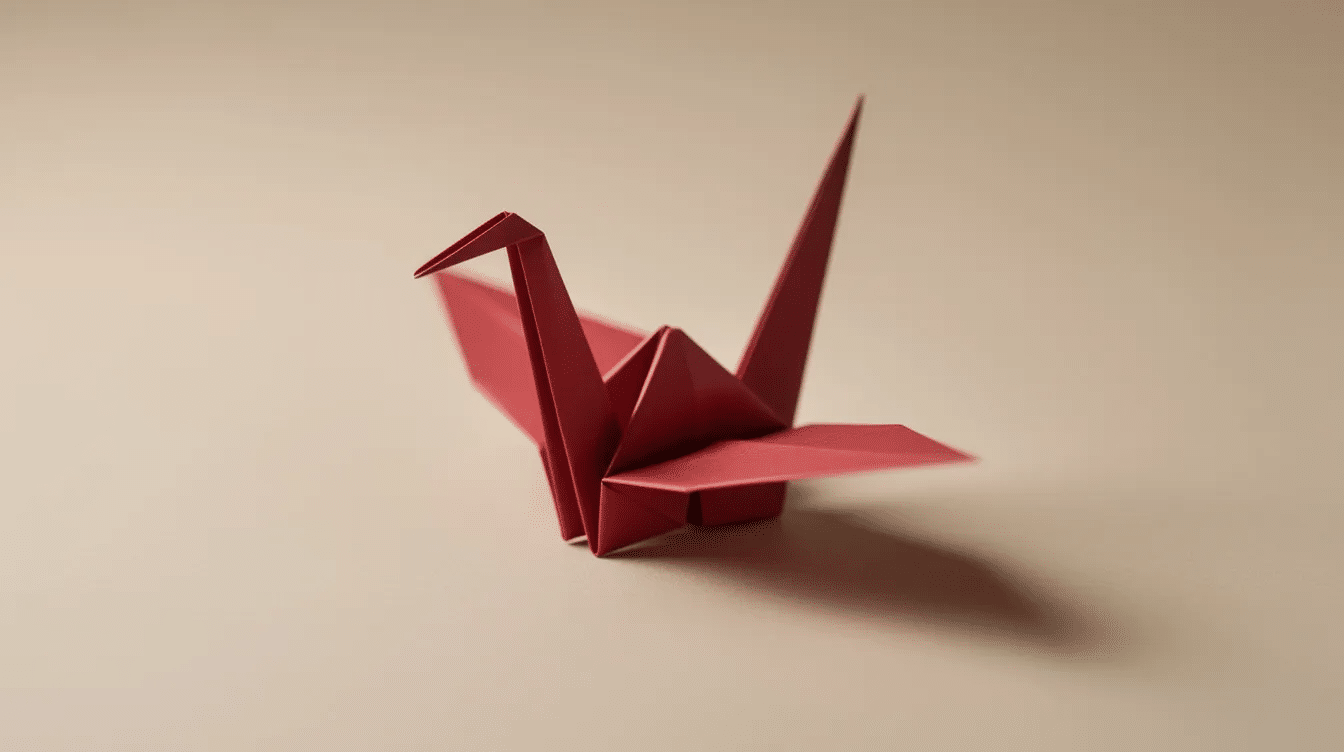 C914ea62 6b36 4bbc aef8 7263b514dcb1 A beautifully crafted red origami crane representing a classic origami animal is displayed against a soft neutral background showcasing the art of folding paper into simple models This elegant piece highlights the beauty of easy origami and serves as an inspiration for beginners looking to explore this fun craft